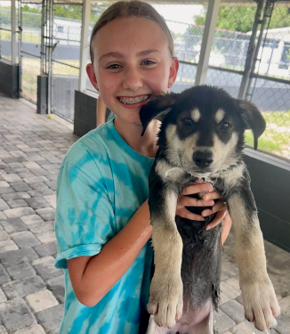 Youth council volunteer holding puppy