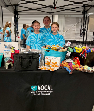Youth council volunteers at donation event in VOCAL's tent
