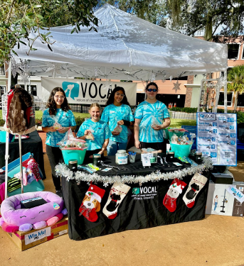 Four of the youth volunteers at a fundraising event at the VOCAL tent